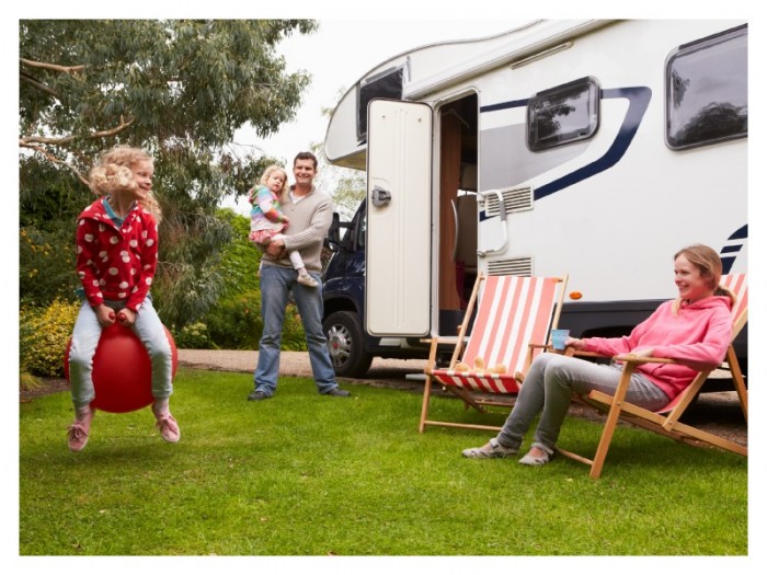Family camping in a tranquil forest setting ideal for sensory-sensitive travelers