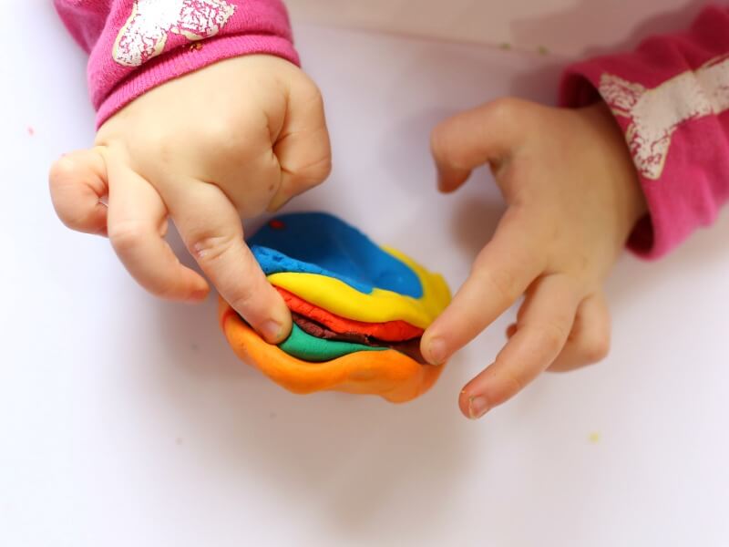 Mixing color play dough with toddlers